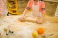 Little girl chef hands with rolling pin