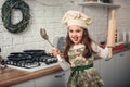 Little girl in a chef hat helps in the kitchen with cooking Royalty Free Stock Photo