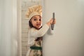 Little girl in a chef hat looks into the refrigerator Royalty Free Stock Photo