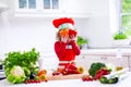 Little girl in chef hat preparing lunch Royalty Free Stock Photo