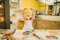 Little girl chef made a funny face out of dough