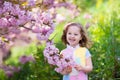 Little girl with cherry blossom Royalty Free Stock Photo