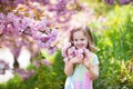 Little girl with cherry blossom Royalty Free Stock Photo