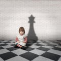 Little girl with a chess queen shadow Royalty Free Stock Photo
