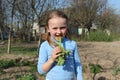 Little girl chewing young sprout of a rhubard Royalty Free Stock Photo