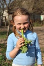 Little girl chewing young sprout of a rhubard Royalty Free Stock Photo