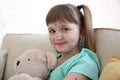 Little girl with chickenpox sitting on sofa Royalty Free Stock Photo