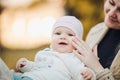 A little girl child in the autumn park smiles, spends time. Beautiful autumn background. Royalty Free Stock Photo