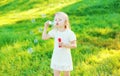 Little girl child blowing soap bubbles in summer Royalty Free Stock Photo