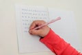 Little girl child doing homework, learning to write letters Royalty Free Stock Photo