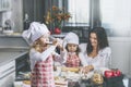 Little girl child drinks milk with her mother and sister happy c