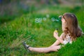 Little girl child enjoying playing with soap bubbles in spring p Royalty Free Stock Photo