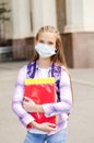 Little girl child with face mask and backpack. Education concept. Back to school after covid-19 Royalty Free Stock Photo