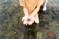 A little girl child holding a starfish in her hands on the seashore. Royalty Free Stock Photo