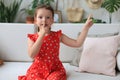 Little girl child keeping finger on her lips and asking to keep quiet Royalty Free Stock Photo