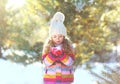 Little girl child playing blowing snow on hands in winter Royalty Free Stock Photo