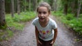 Little girl child running in forest and inviting to run together
