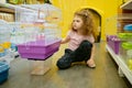 Little girl child sitting nearby cage for rodent at pet shop Royalty Free Stock Photo