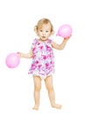 Little girl child standing holding balloons. Kid w
