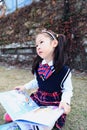 Little cute girl Child reading a book on the grass Royalty Free Stock Photo