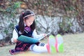 Little girl Child reading a book on the grass Royalty Free Stock Photo