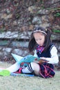 Little girl Child reading a book on the grass Royalty Free Stock Photo