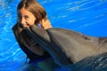 Little girl children kissing a gorgeous dolphin flipper smiling face happy kid swim bottle nose dolphins Royalty Free Stock Photo