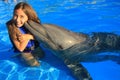 Little girl children kissing a gorgeous dolphin flipper smiling face happy kid swim bottle nose dolphins