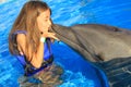 Little girl children kissing a gorgeous dolphin flipper smiling face happy kid swim bottle nose dolphins Royalty Free Stock Photo