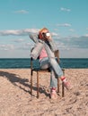 Little girl chilling resting in beach chair Happy child smiling relaxing enjoying life sun fresh air Distance e-learning Royalty Free Stock Photo