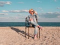 Little girl chilling resting in beach chair Happy child smiling relaxing enjoying life sun fresh air Distance e-learning Royalty Free Stock Photo