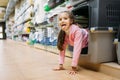 Little girl chooses carrier for puppy in pet shop Royalty Free Stock Photo