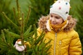 Little girl choosing christmas tree at market Royalty Free Stock Photo