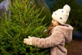 Little girl choosing christmas tree at market Royalty Free Stock Photo