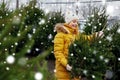 Little girl choosing christmas tree at market Royalty Free Stock Photo