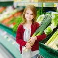 Little girl choosing a leek in a store Royalty Free Stock Photo