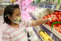 Little girl choosing tomatoes in a food store Royalty Free Stock Photo