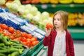 Little girl choosing tomatoes in a food store Royalty Free Stock Photo