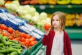Little girl choosing tomatoes in a food store Royalty Free Stock Photo