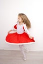 Little girl in a Christmas dress dancing Royalty Free Stock Photo