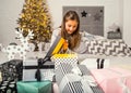 Little girl at christmas opens gifts
