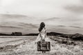 Little girl in classic dress with travel suitcase