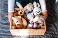 Little girl cleaning up the toy box at home.