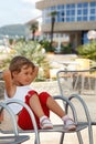 Little girl, clear summer day sitting in armchair Royalty Free Stock Photo