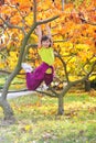 Little girl climbed on tree Royalty Free Stock Photo