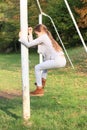 Little girl climbing on football wicket