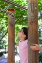 Little girl climbing on a monkey bars in the park in summer Royalty Free Stock Photo