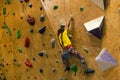 little girl climbing a rock wall indoor Royalty Free Stock Photo