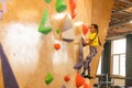 little girl climbing a rock wall indoor Royalty Free Stock Photo