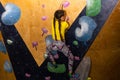 little girl climbing a rock wall indoor Royalty Free Stock Photo